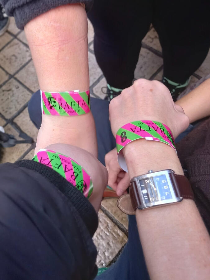 Protect the Heart of the arts campaign members showing off their BAFTA wristbands